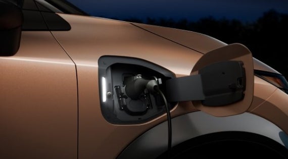 Close-up image of charging cable plugged in | Winners Circle Nissan in Hampton VA